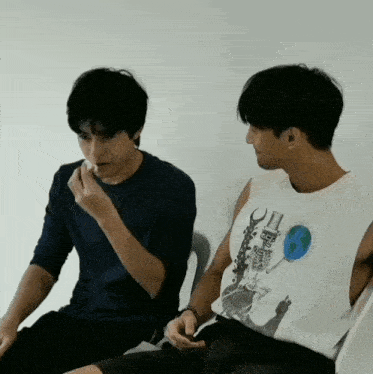 two men are sitting next to each other one wearing a shirt that says ' a few dollars ' on it