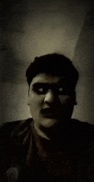 a close up of a man 's face with his mouth open and his eyes glowing