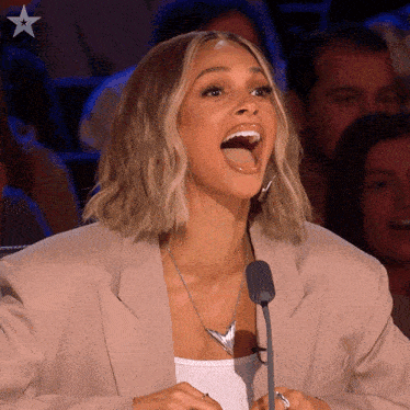 a woman with her mouth open and a microphone in front of her