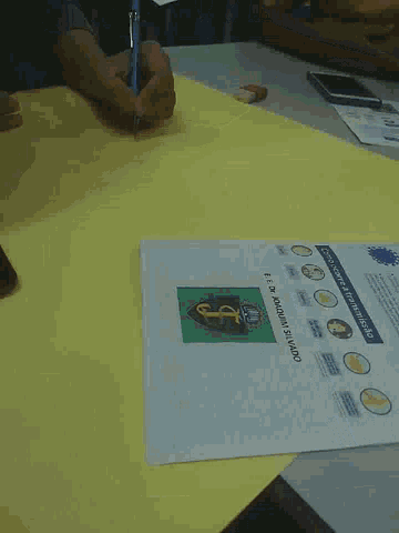 a person is writing on a piece of paper that says e.e. dr. joaquin silvado