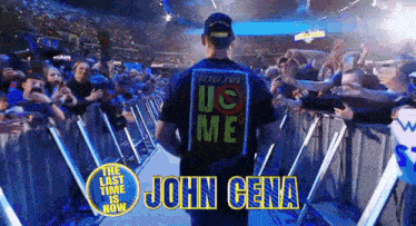 a man wearing a shirt that says us me is walking through a crowd