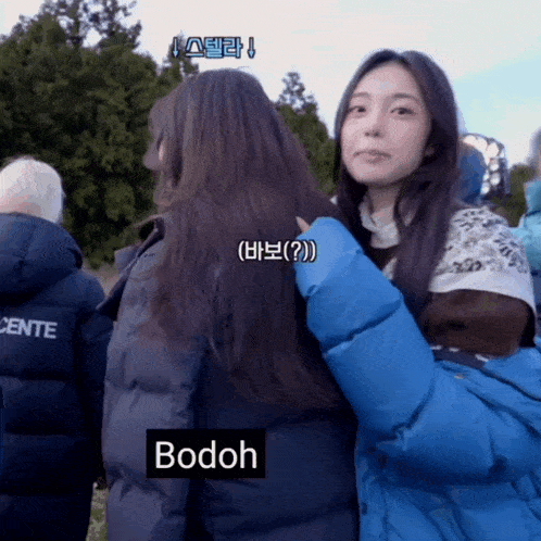 a woman in a blue jacket with bodoh written on the bottom