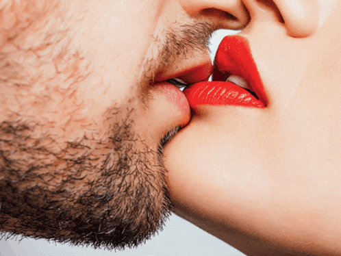 a man and woman are kissing with red lips