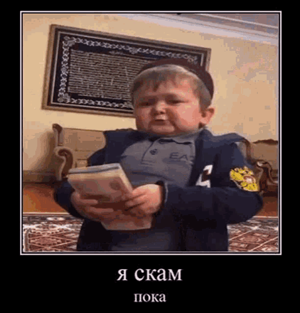 a little boy is holding a large amount of money in his hands .