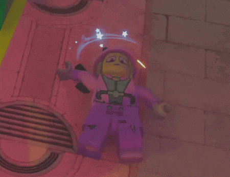 a purple lego figure with a yellow face and a hood
