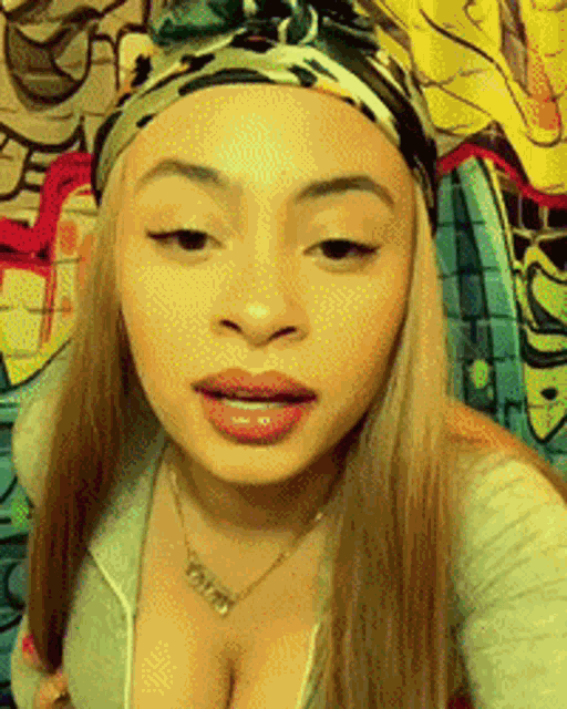 a woman wearing a headband and a necklace with the word faith written on it