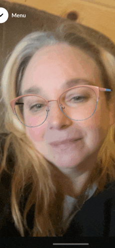 a close up of a woman wearing glasses and a menu button