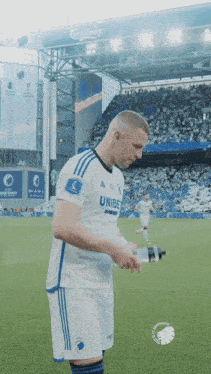 a soccer player wearing a white shirt with the word unibe on the front