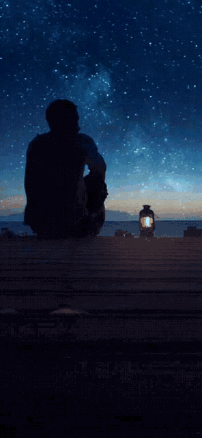 a poster that says good night sweet dreams with a man sitting on the beach