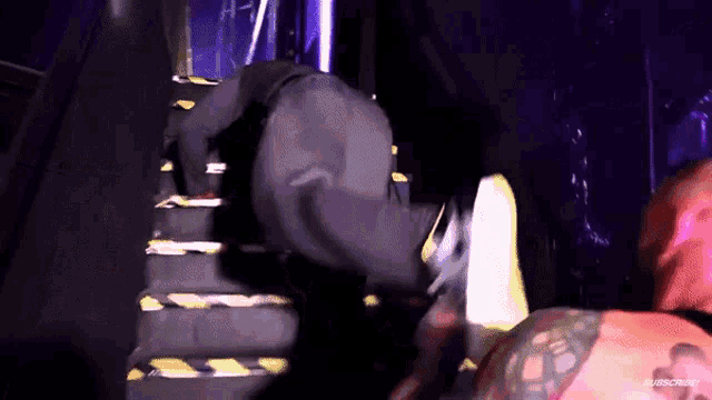 a man is standing on a set of stairs with his feet up .