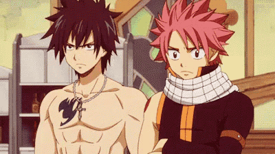 a couple of anime characters are standing next to each other .