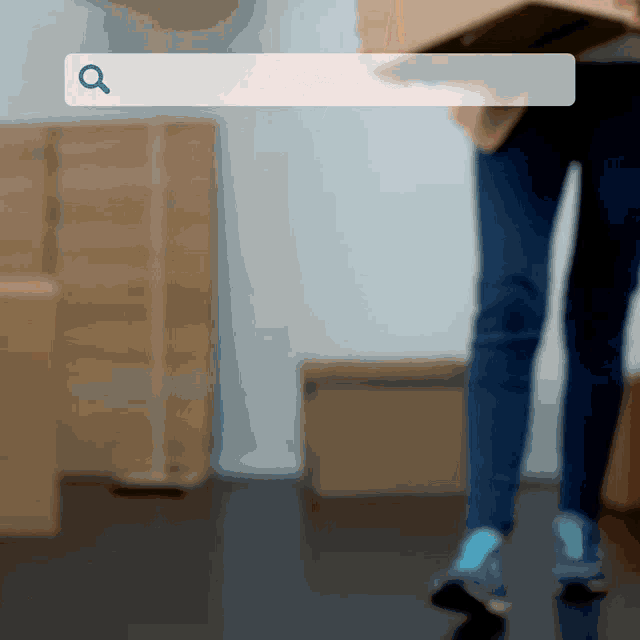 a person carrying a cardboard box with a search bar in the foreground