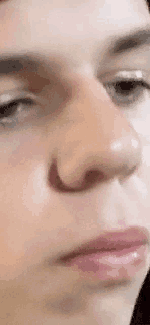 a close up of a person 's face with a nose ring .