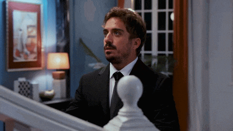 a man in a suit and tie is standing in a room