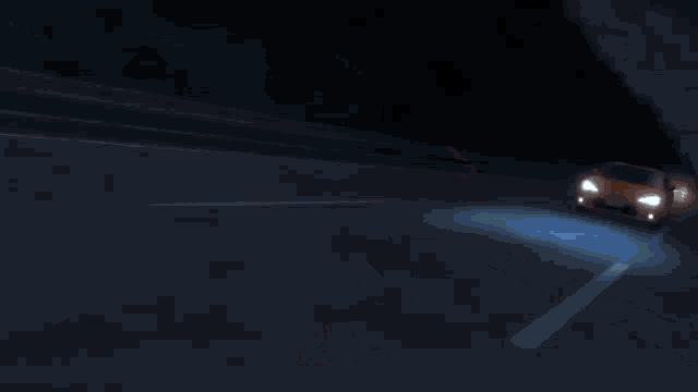 a car is driving down a highway at night