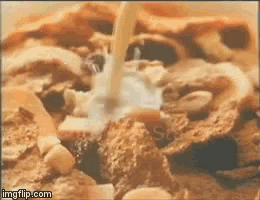 a close up of a bowl of cereal with milk being poured on it