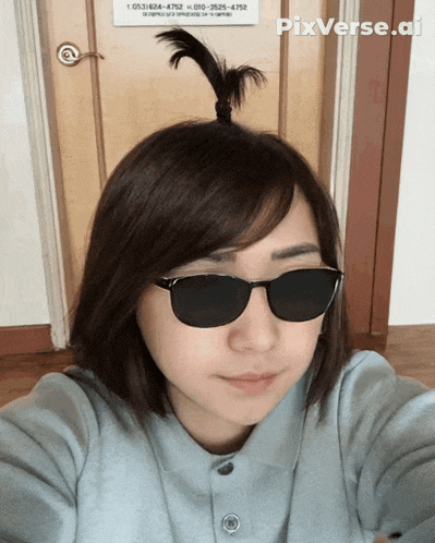 a woman wearing sunglasses takes a selfie in front of a door that has pixverse.ai written on it