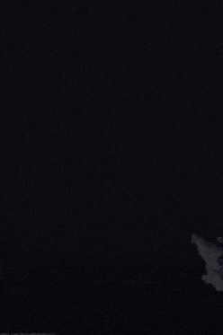a lightning strike is visible in the sky above a mountain