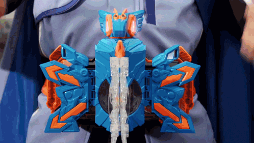 a person is wearing a blue and orange toy that looks like a butterfly