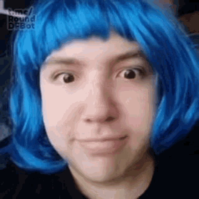 a woman wearing a blue wig is making a face .