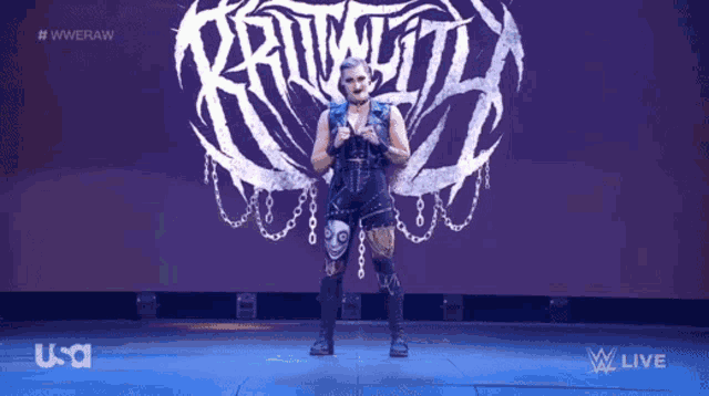 a female wrestler is standing in front of a wrestling logo that says raw