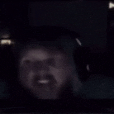 a man with a beard wearing headphones is looking at a computer screen .