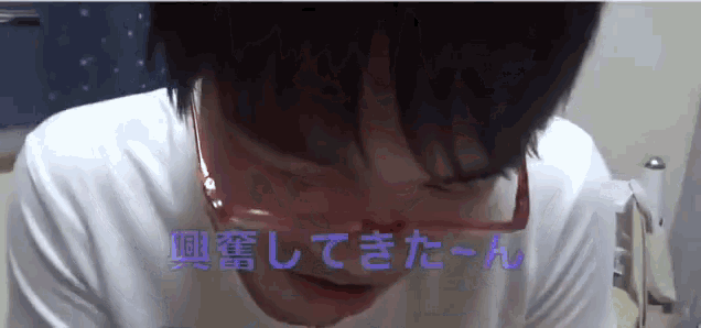 a close up of a person 's face with chinese writing behind it