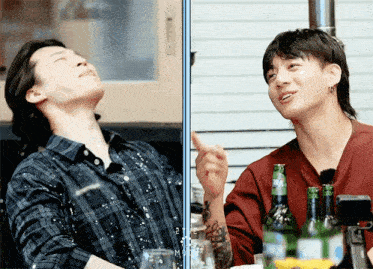 a man in a plaid shirt is laughing next to another man in a red shirt