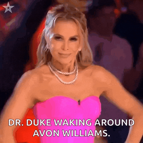 a woman in a pink strapless dress is smiling and says dr. duke waking around avon williams .