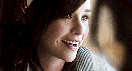 a close up of a woman 's face smiling with her mouth open