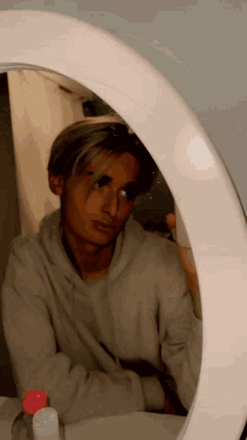 a man is taking a selfie in front of a mirror