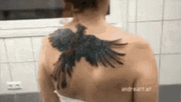 a woman with a bird tattoo on her back