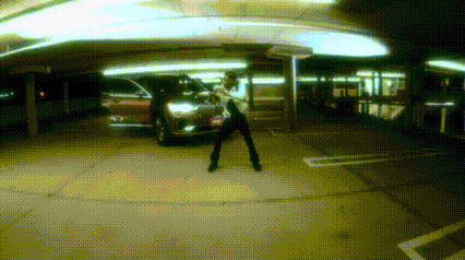 a person is standing in a parking lot with a car in the background
