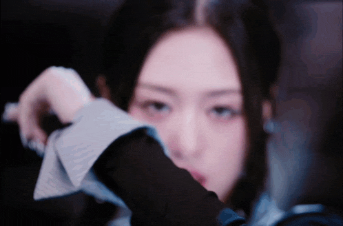 a close up of a woman 's face with a blurred background