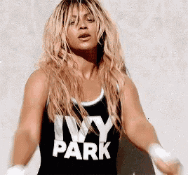 a woman is wearing a black tank top that says ivy park on it