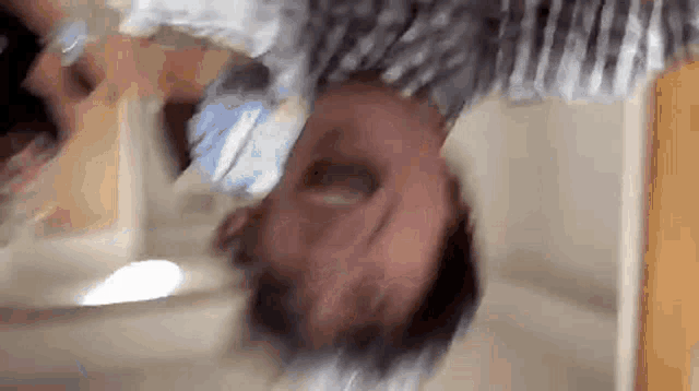 a man is laying on his back in front of a mirror .