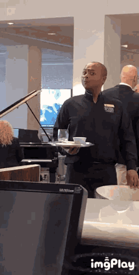 a man holding a tray with a name tag that says brian
