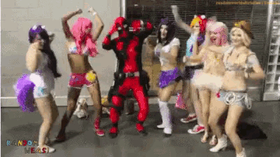 a group of people dressed in costumes are dancing in front of a sign that says ron of the beast