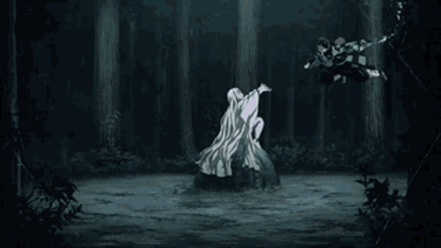 a man is standing next to a statue of a man in a white robe in a forest .