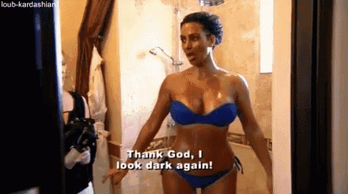 a woman in a blue bikini is standing in a bathroom .