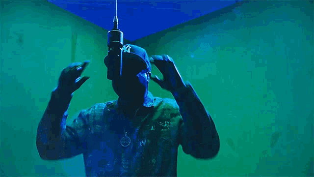 a man in a mask is holding a microphone and the words stay fly are above him