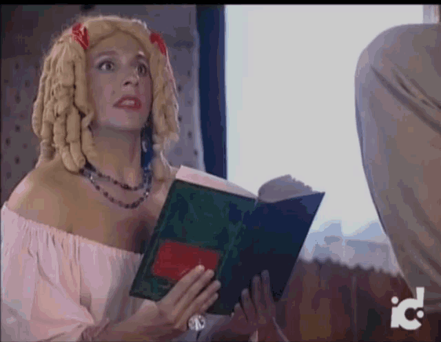 a woman in a wig is reading a book with the letters ic on the bottom left