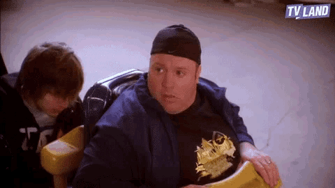 a man is riding a roller coaster with a tv land logo behind him .