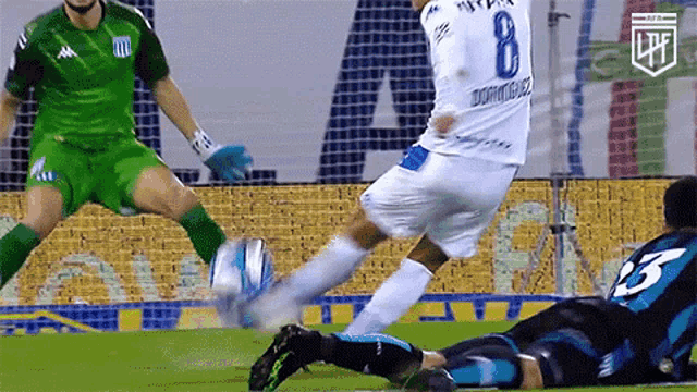 a soccer player with the number 8 on his jersey is kicking a ball