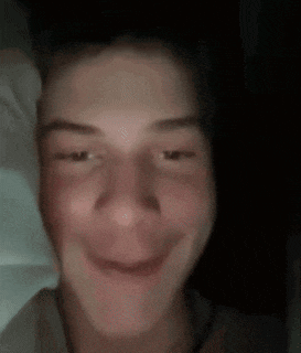 a close up of a person 's face with their eyes closed and smiling .