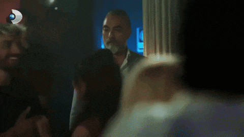 a woman in a green dress is looking at a man .