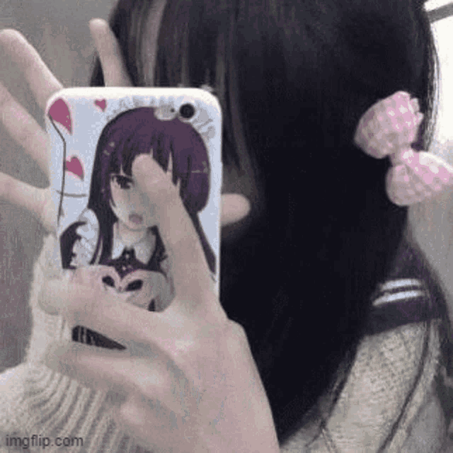 a girl is taking a selfie with her phone in front of a mirror .