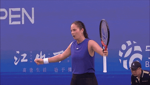 a woman is holding a tennis racquet in front of a sign that says i have the time