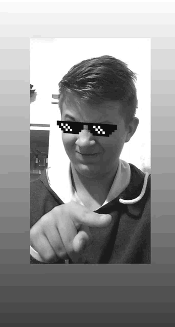 a black and white photo of a young boy wearing sunglasses