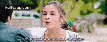 a woman is talking to a man and says oh my wedding is in one and a half months !
